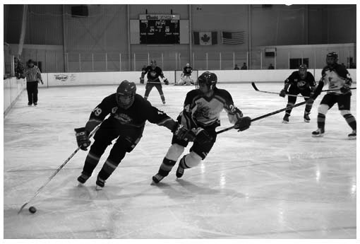 The Mt. Brydges Bulldogs and Lambeth Lancers battle on the ice.